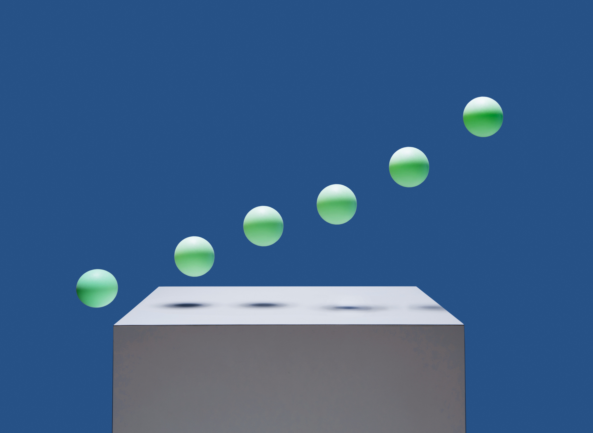 6 green balls bouncing off of white box in ascending order, blue background