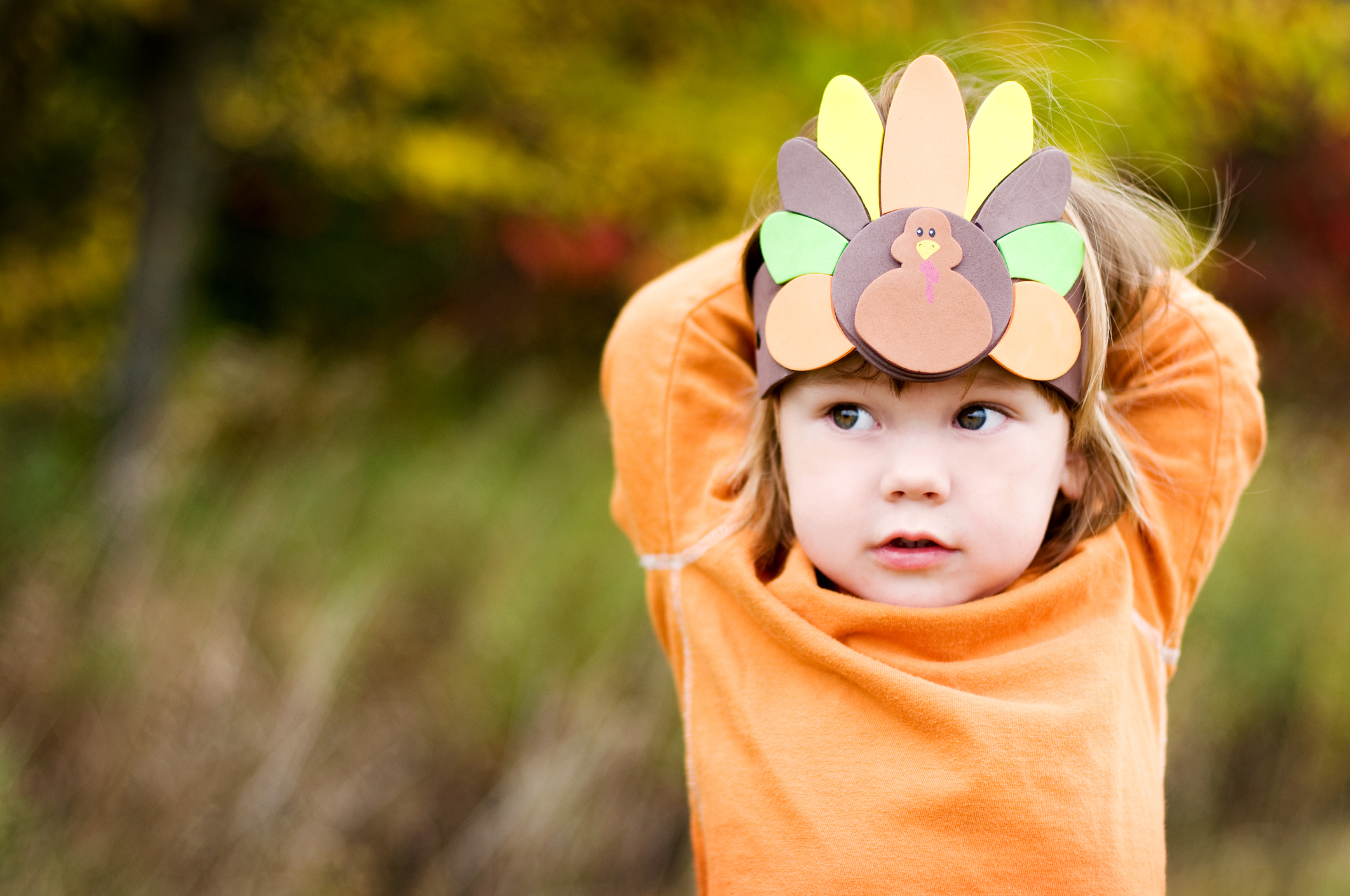 Little boy with a Turkey hat.  Focus on the hat.