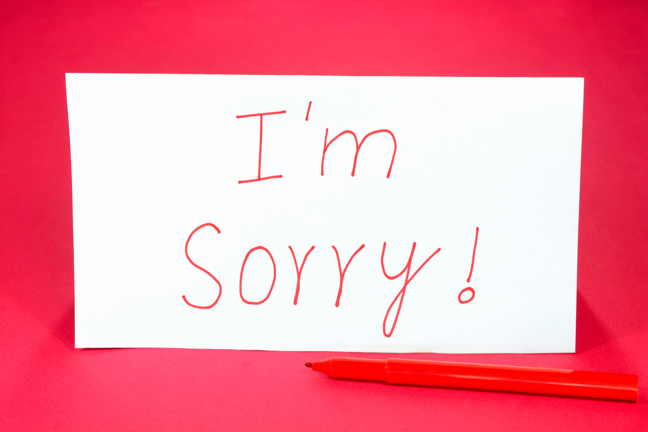 Text with I&#039;m Sorry word written on a card with red colored pen.