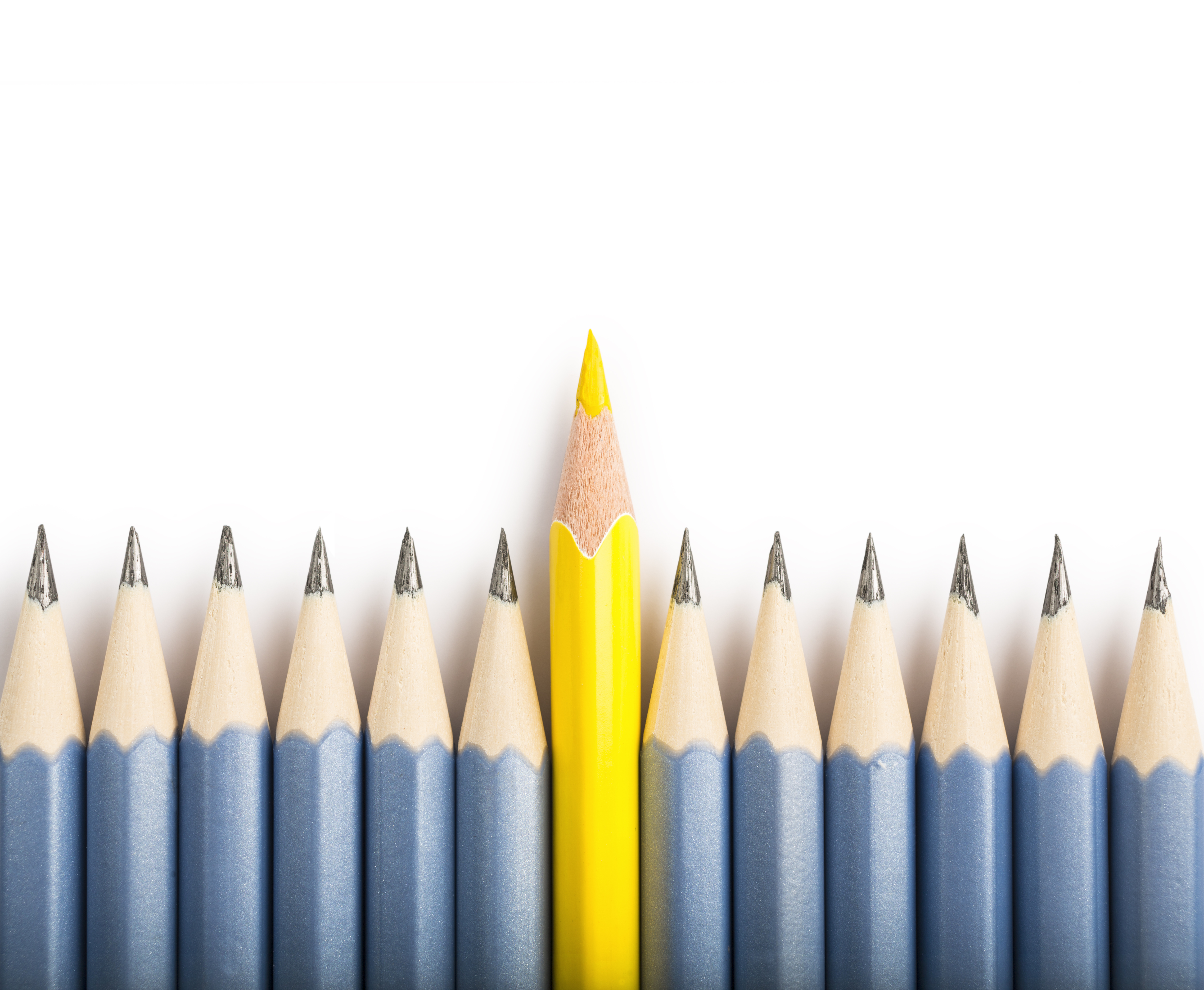 View directly from above of a group of pencils in which a yellow pencil differs from the others and stands out from the crowd. Concept of individual, standing out from the crowd and business purposes. The crayons are nicely isolated on a white background, with a natural shadow (studio shot in macro mode).