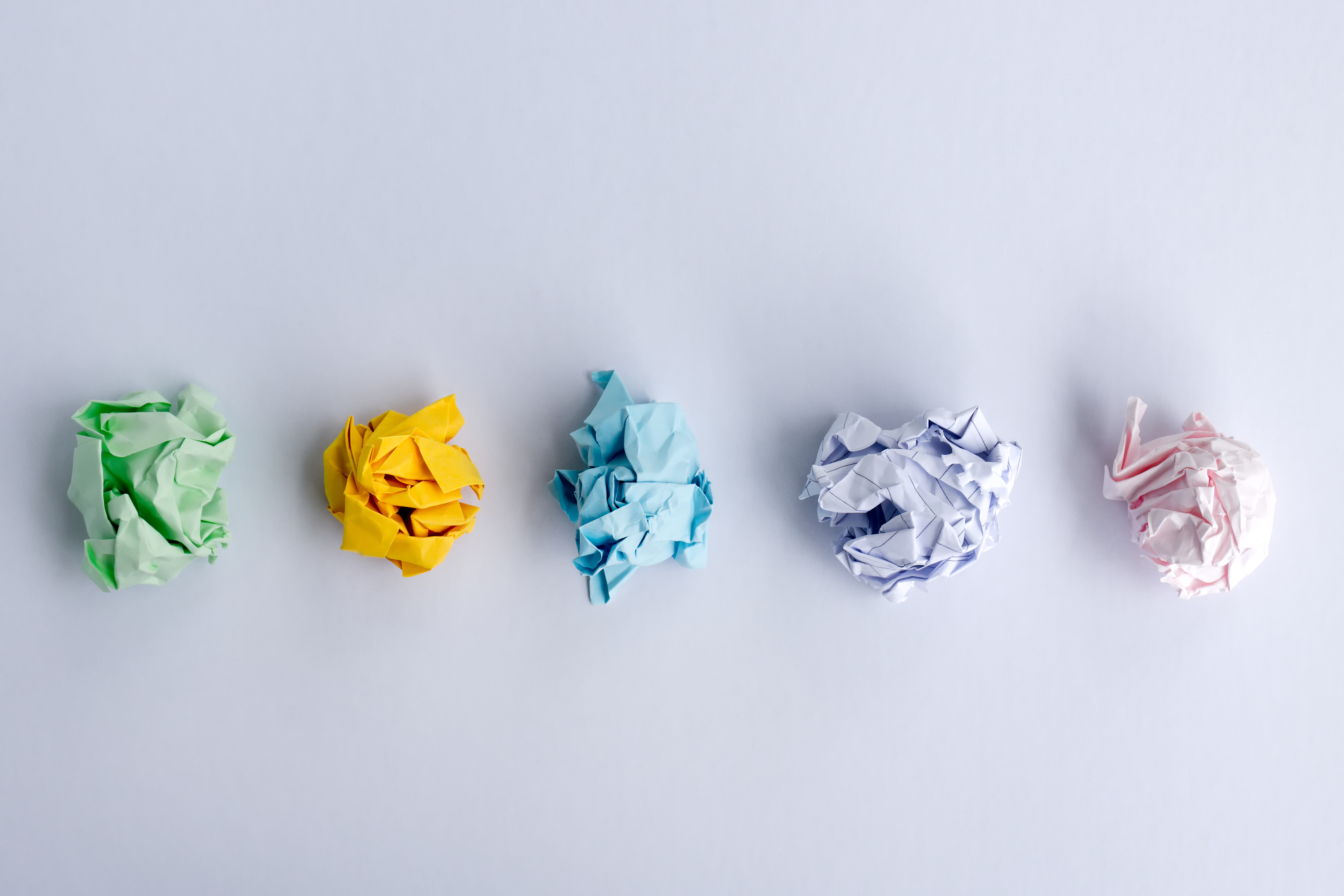 Top view of crumpled papers on white background