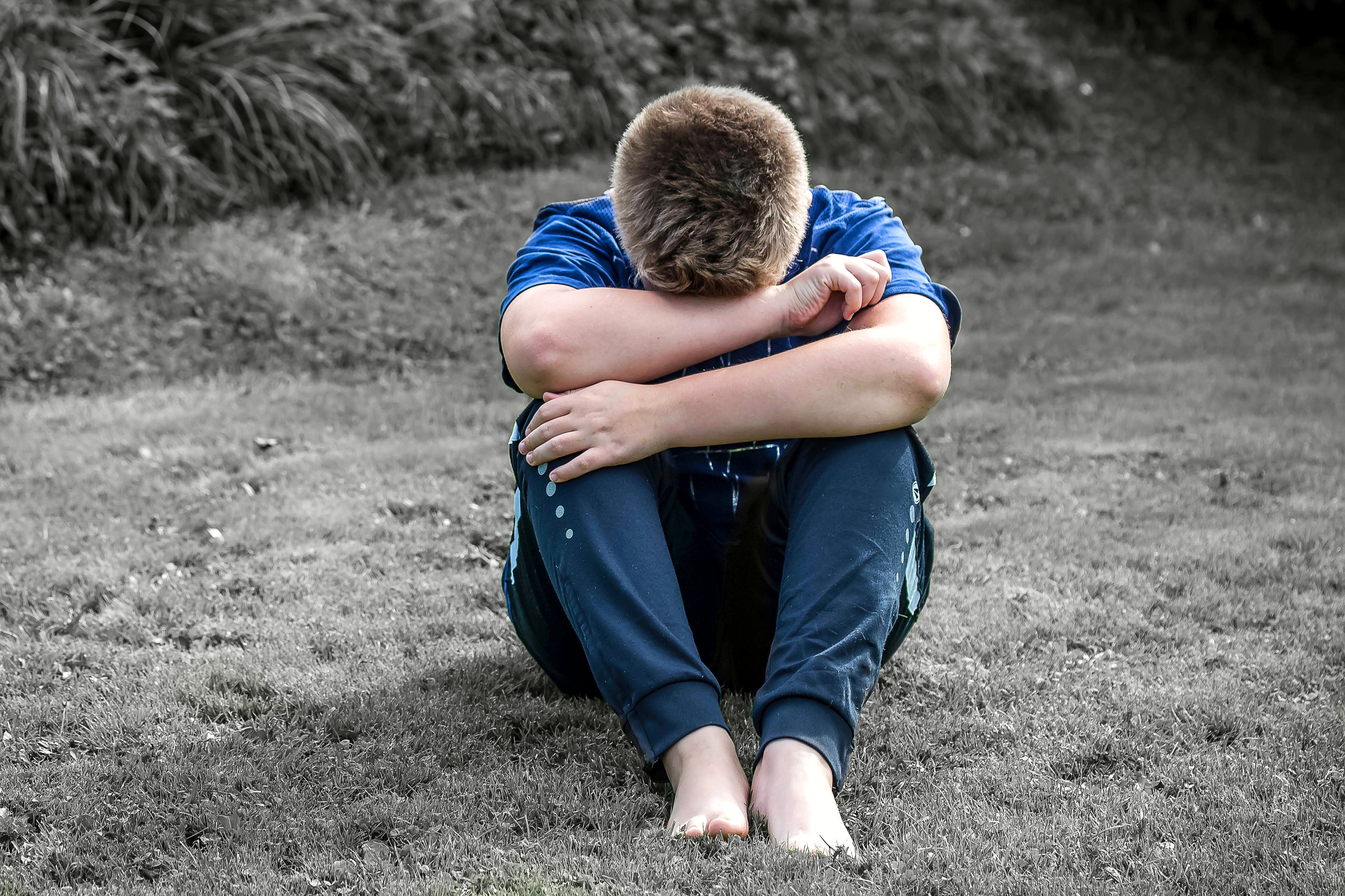A boy sitting in sorrow
