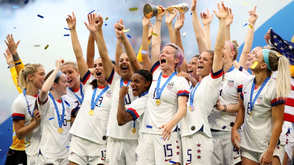LYON, FRANCE - JULY 07: Megan Rapinoe and USA players celebrate as they lift the trophy during the 2019 FIFA Women&#039;s World Cup France Final match between The United States of America and The Netherlands at Stade de Lyon on July 7, 2019 in Lyon, France. (Photo by Marc Atkins/Getty Images)