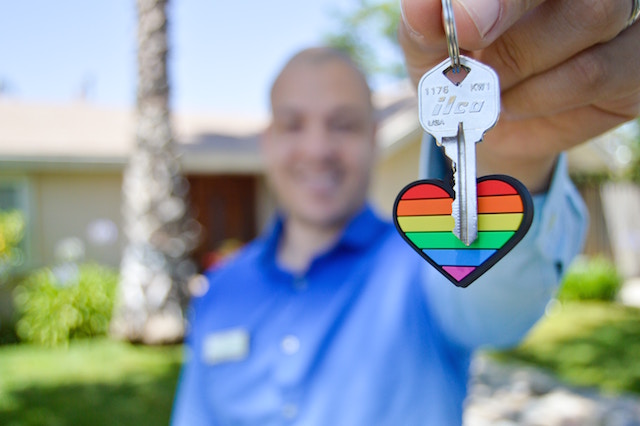 A real estate worker offers you a key to your new home.