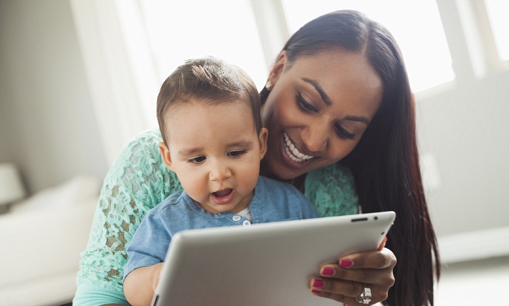 Mother and son using digital tablet --- Image by © Mike Kemp/Blend Images/Corbis