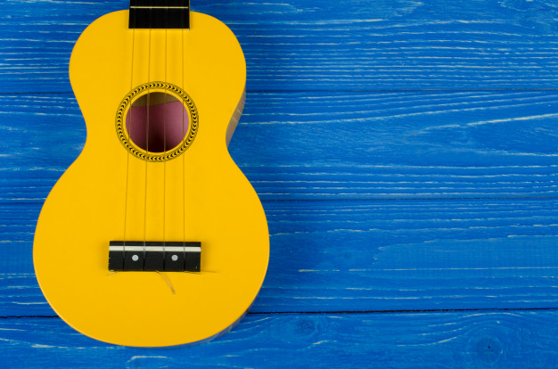 (https://www.freepik.com/premium-photo/yellow-ukulele-guitar-blue-background_5266217.htm)