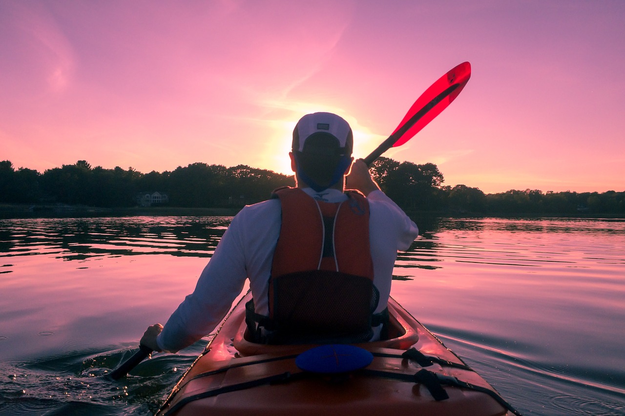 Man Kayaking at Sunset