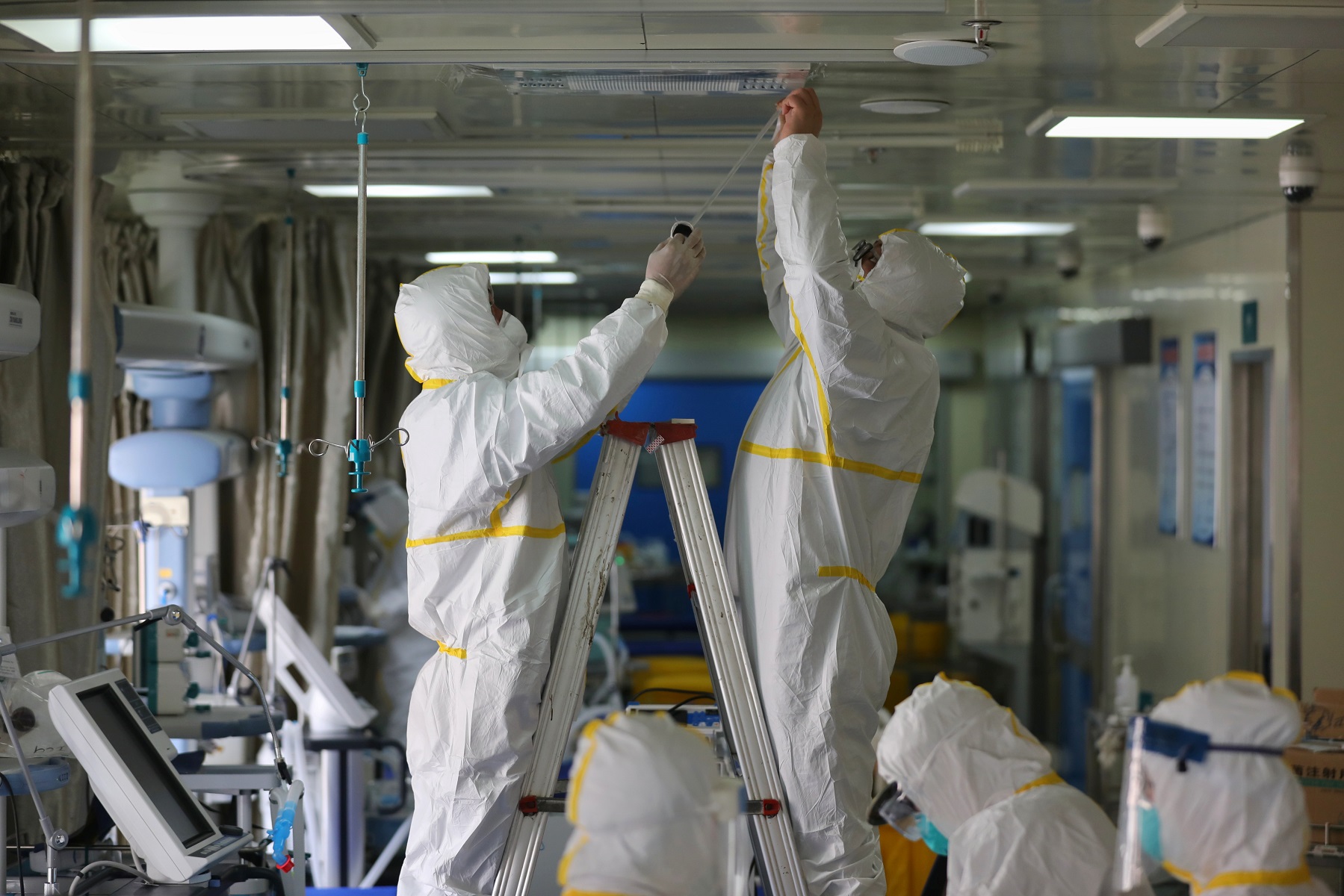 Medical workers in protective suits disinfect an intensive care unit (ICU) ward of Union Jiangbei Hospital in Wuhan, the epicentre of the novel coronavirus outbreak, Hubei province, China March 12, 2020. Picture taken March 12, 2020. China Daily via REUTERS  ATTENTION EDITORS - THIS IMAGE WAS PROVIDED BY A THIRD PARTY. CHINA OUT.