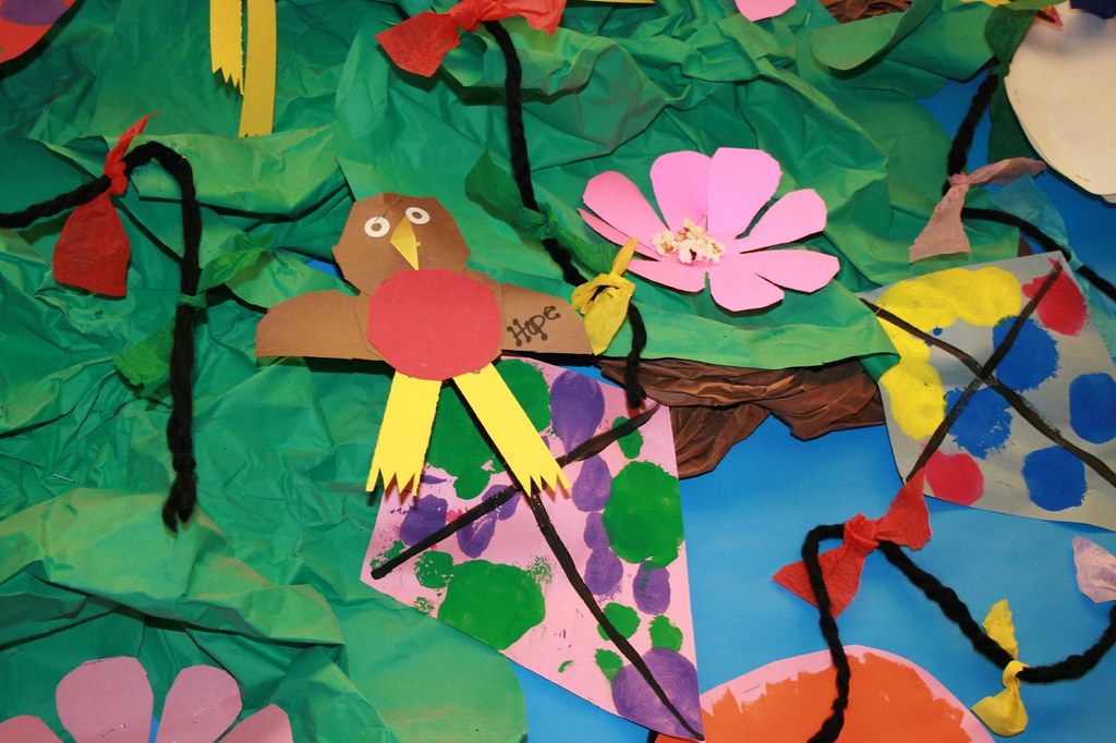 A child&#039;s collage of birds and flowers.