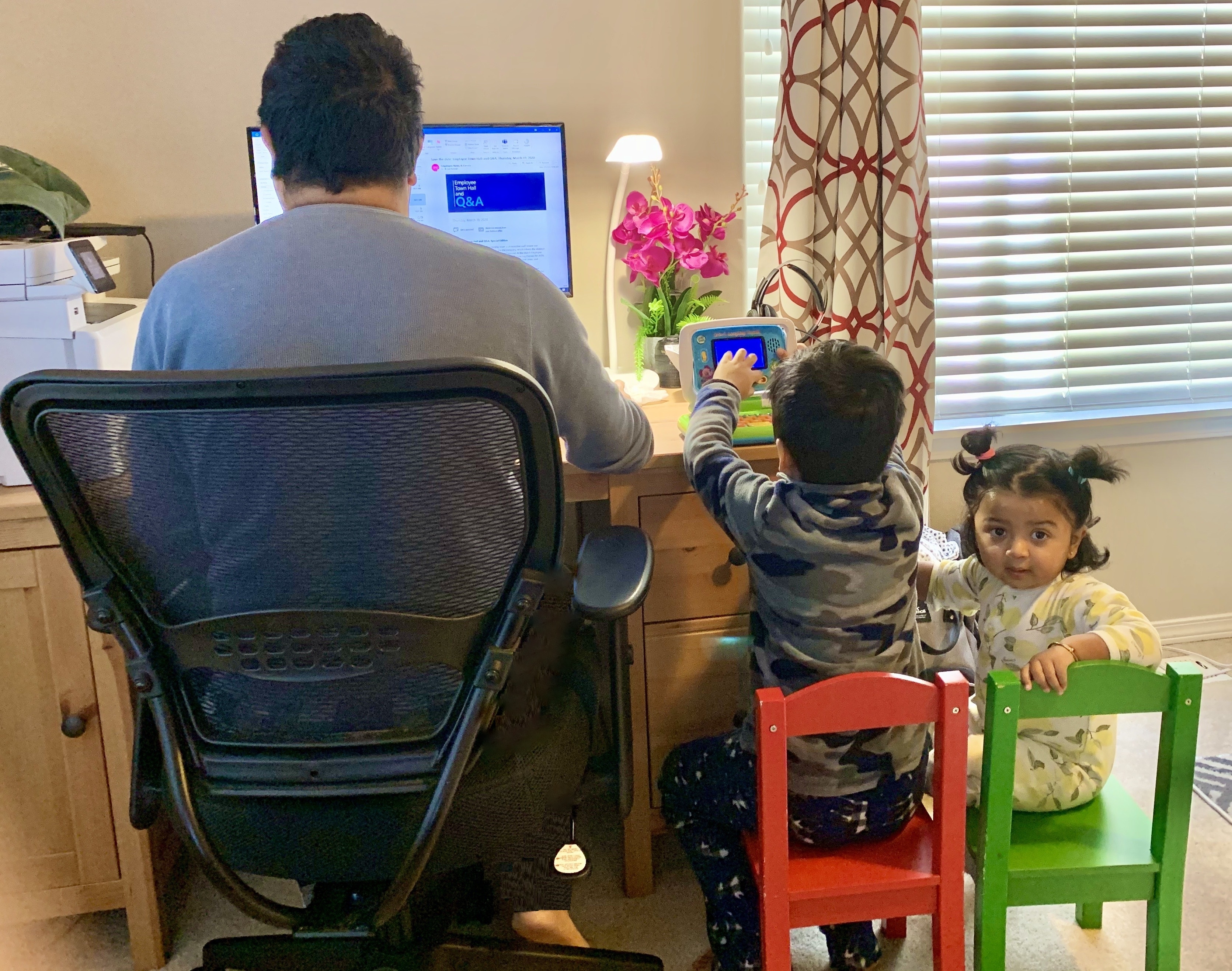 A Dad with his kids while working from home (Photo taken by the Mom)