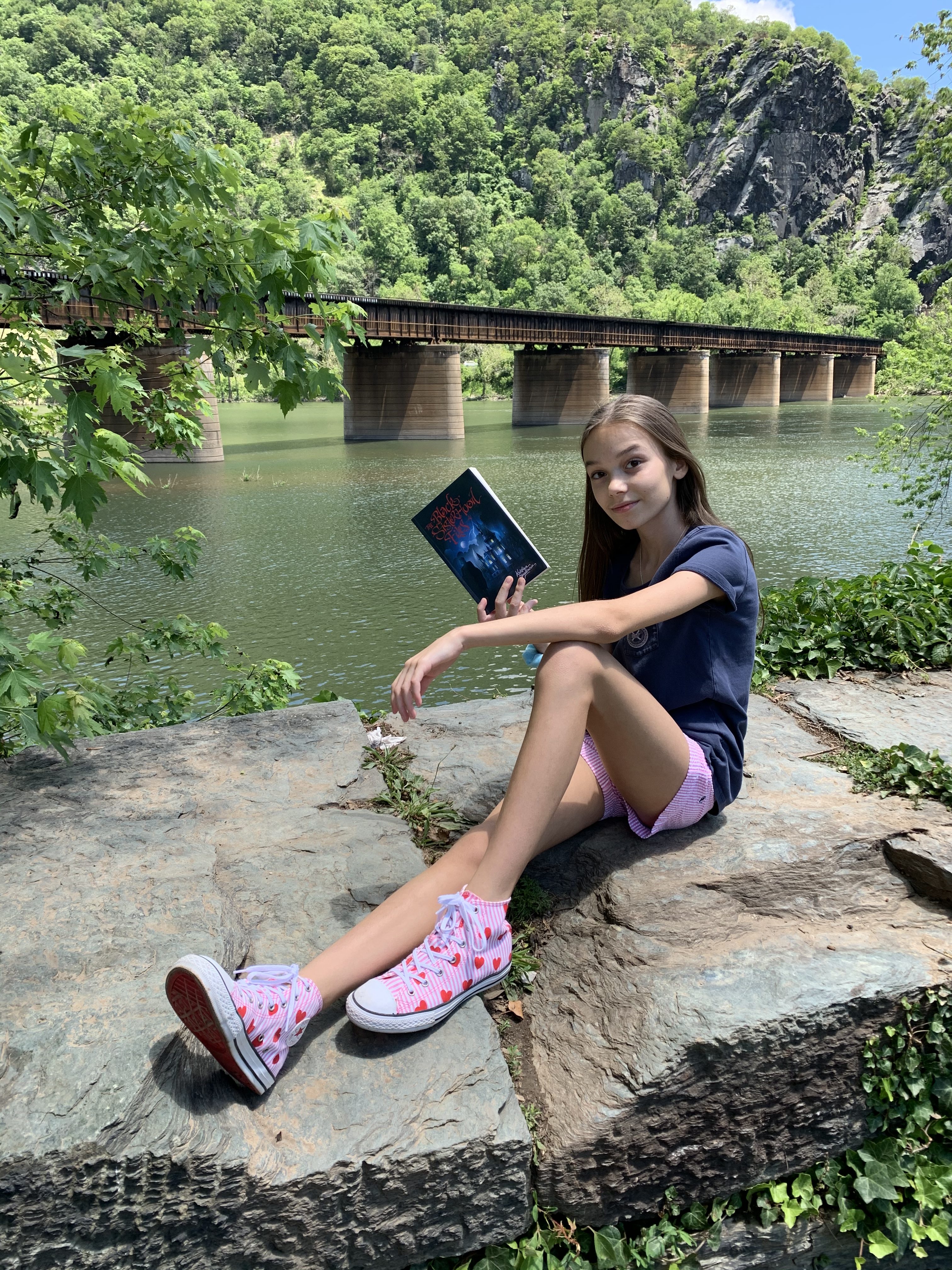 A photo of Kristina with her novel, The Black Sisterhood Files, in West Virginia where the book is set.