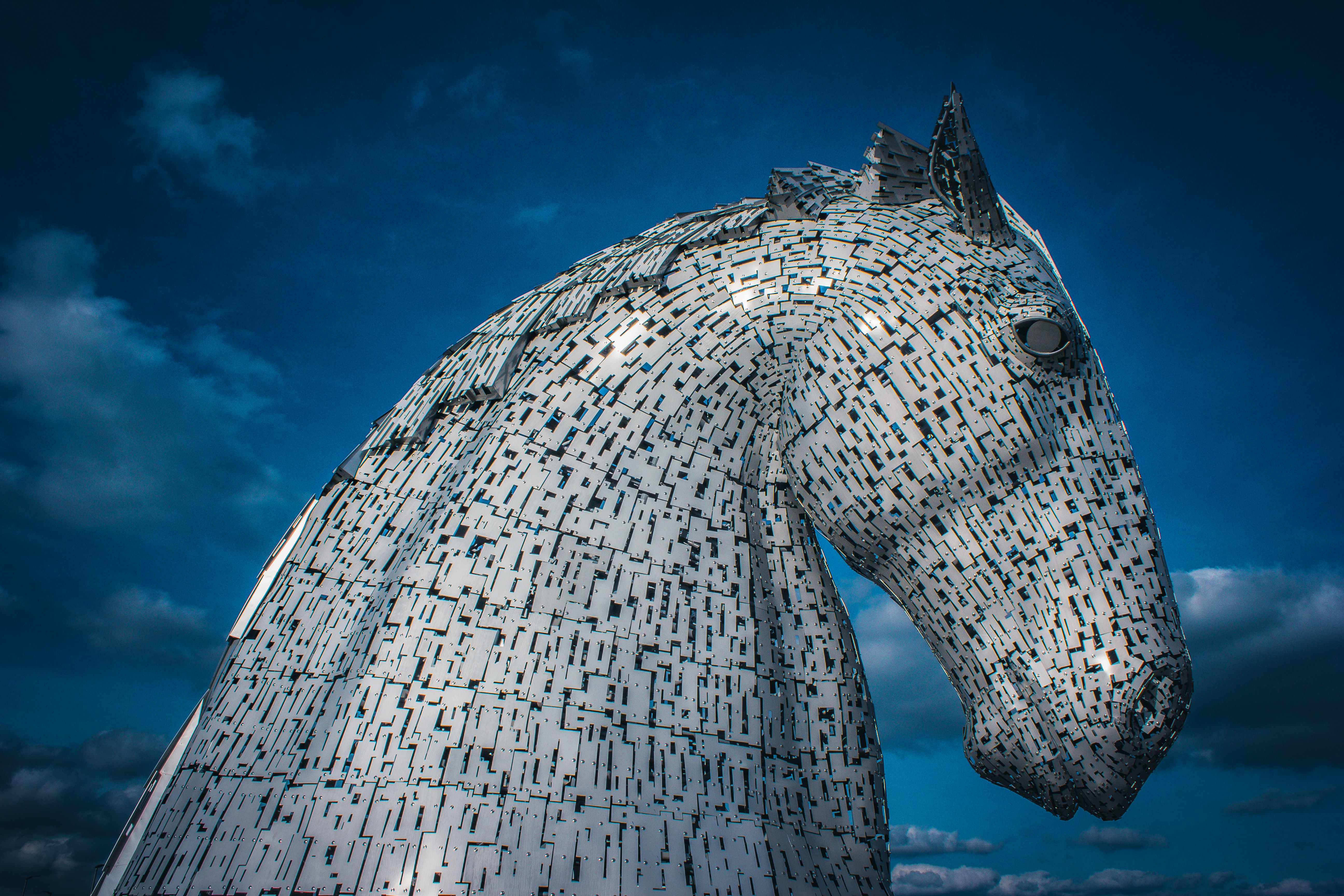 metal horse sculpture against blue sky
