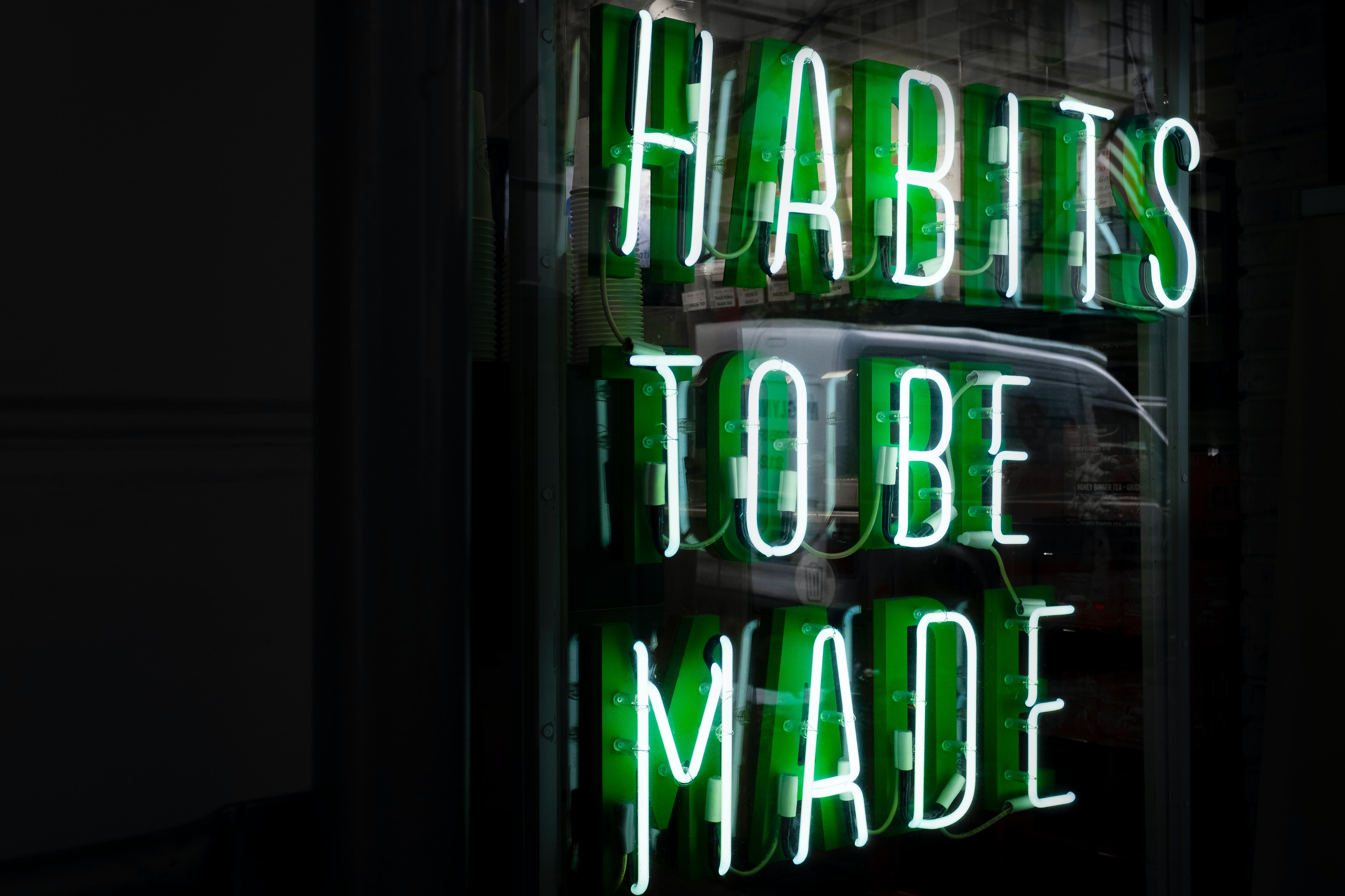 green neon sign reading habits to be made