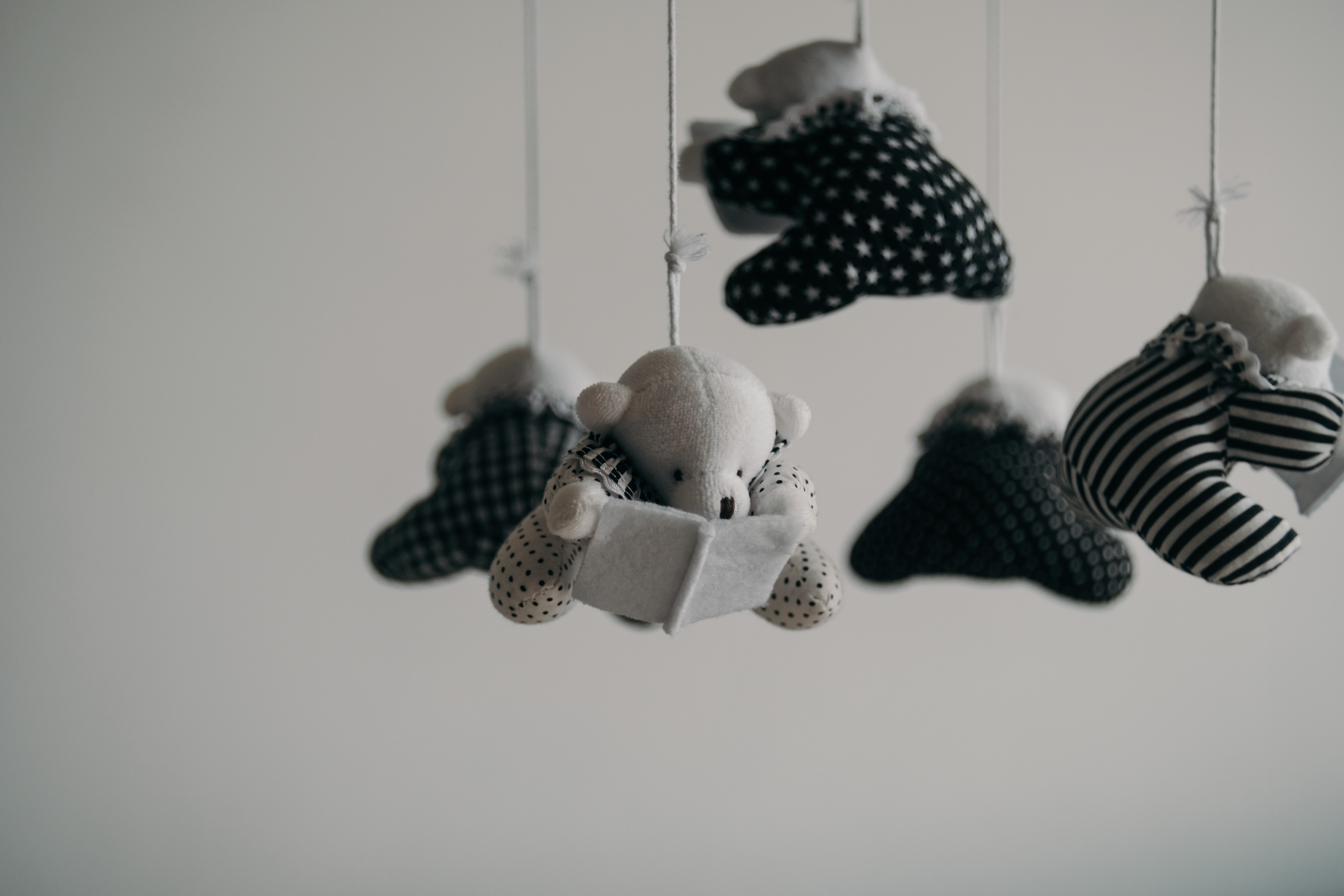 The black and white baby mobile represents the intersection between infertility trauma and racial trauma.