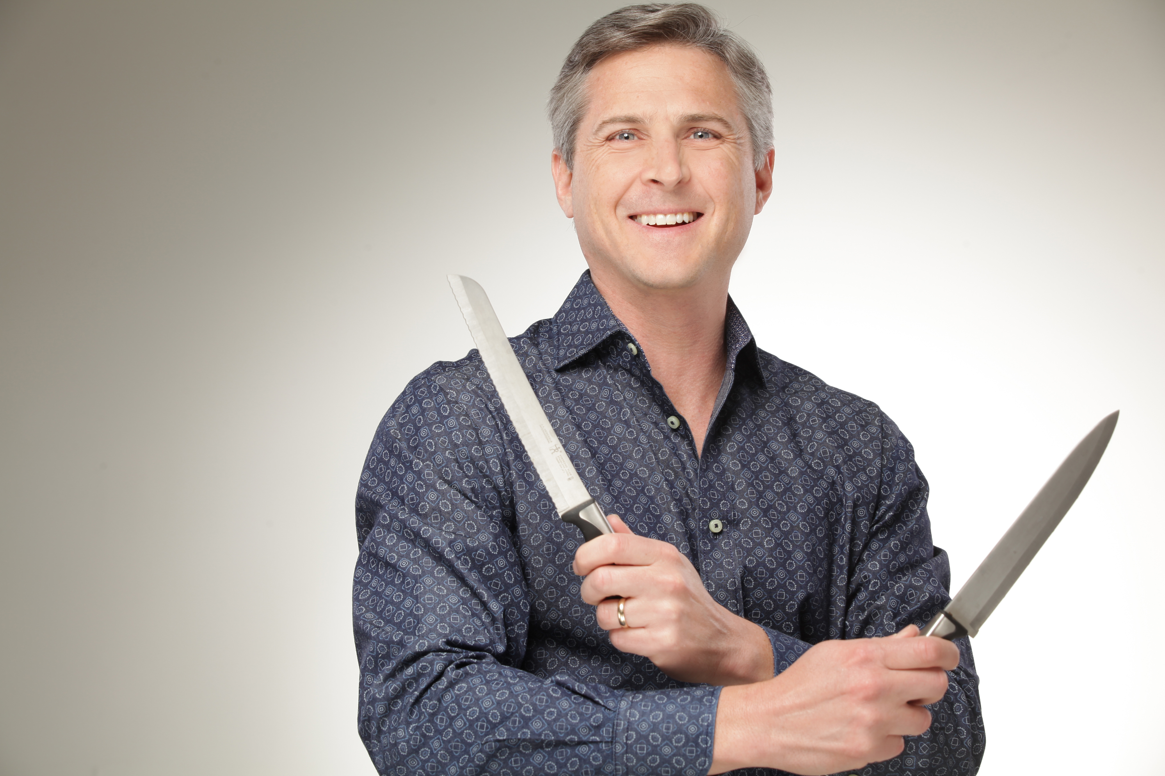 Dr. Blake Shusterman, aka &quot;The Cooking Doc&quot; holds two steak knives