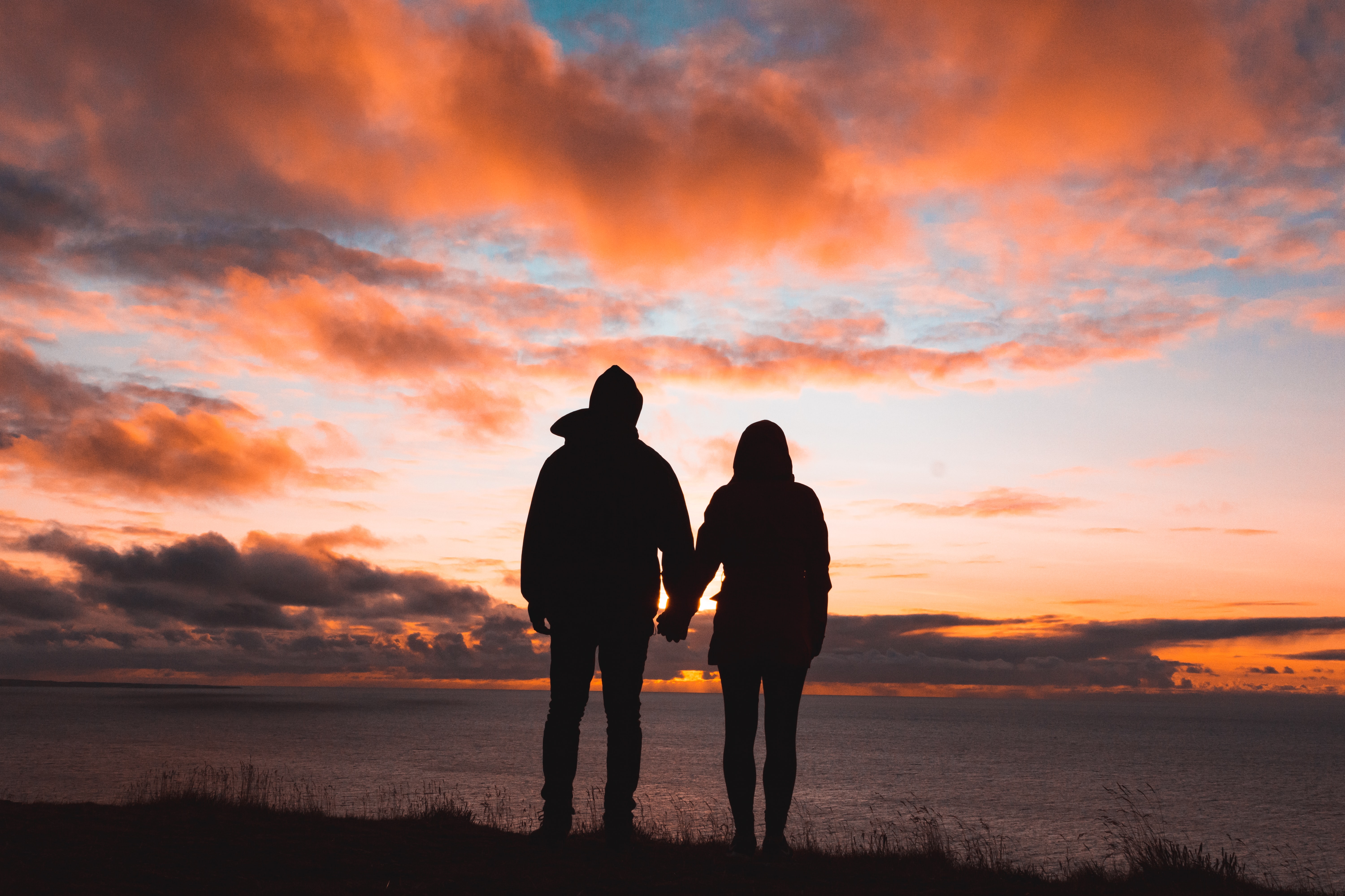 two people walking at sunset