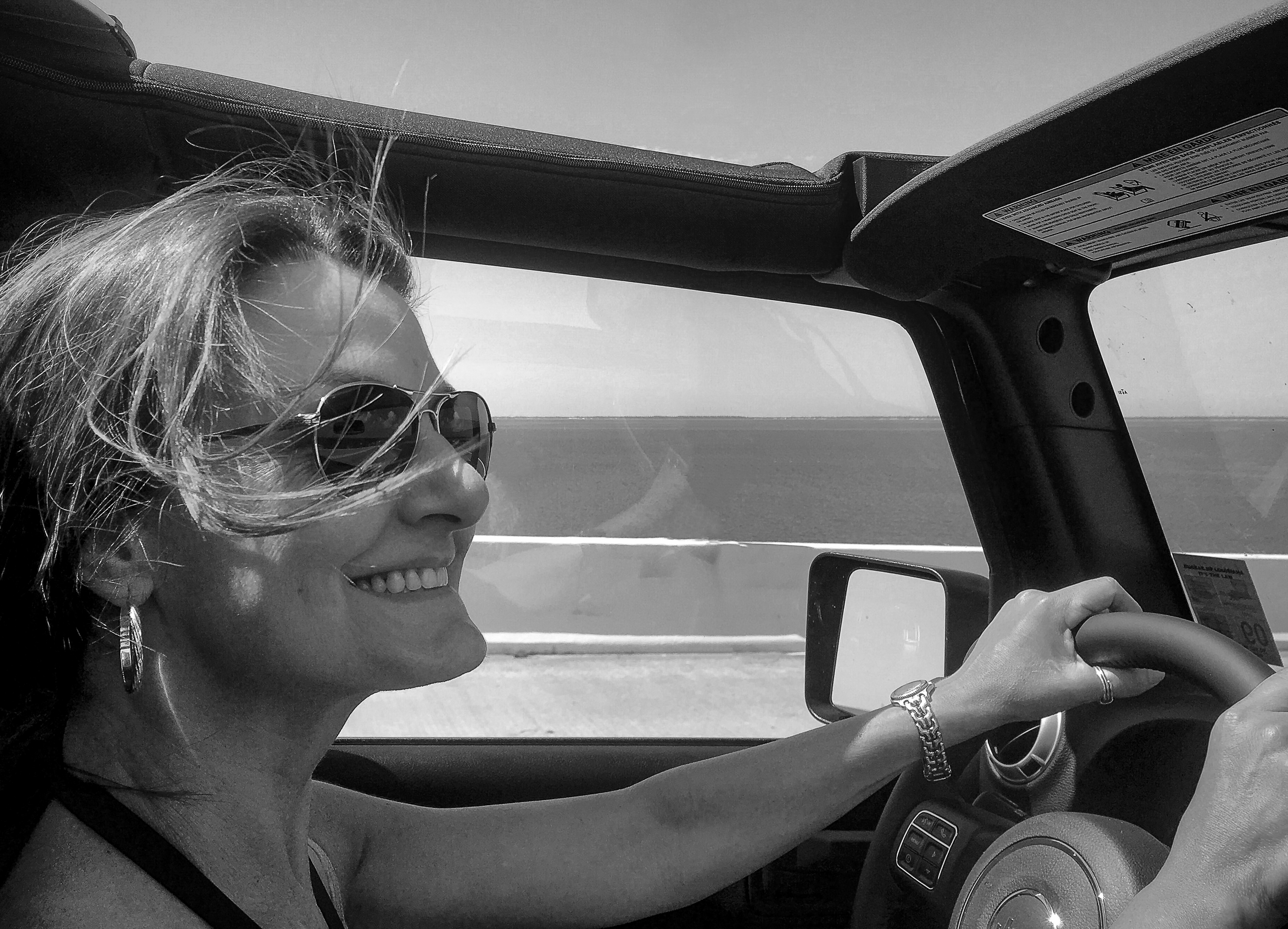 Carole driving her Jeep Wrangler on a sunny Cinco de Mayo.