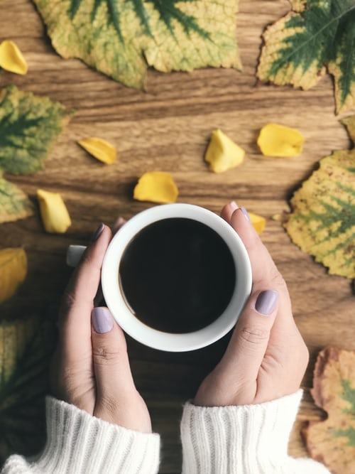 Unsplash: Person holding cup of coffee