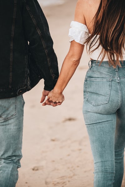 Unsplash: Man and Woman Holding Hands in Denim Jeans