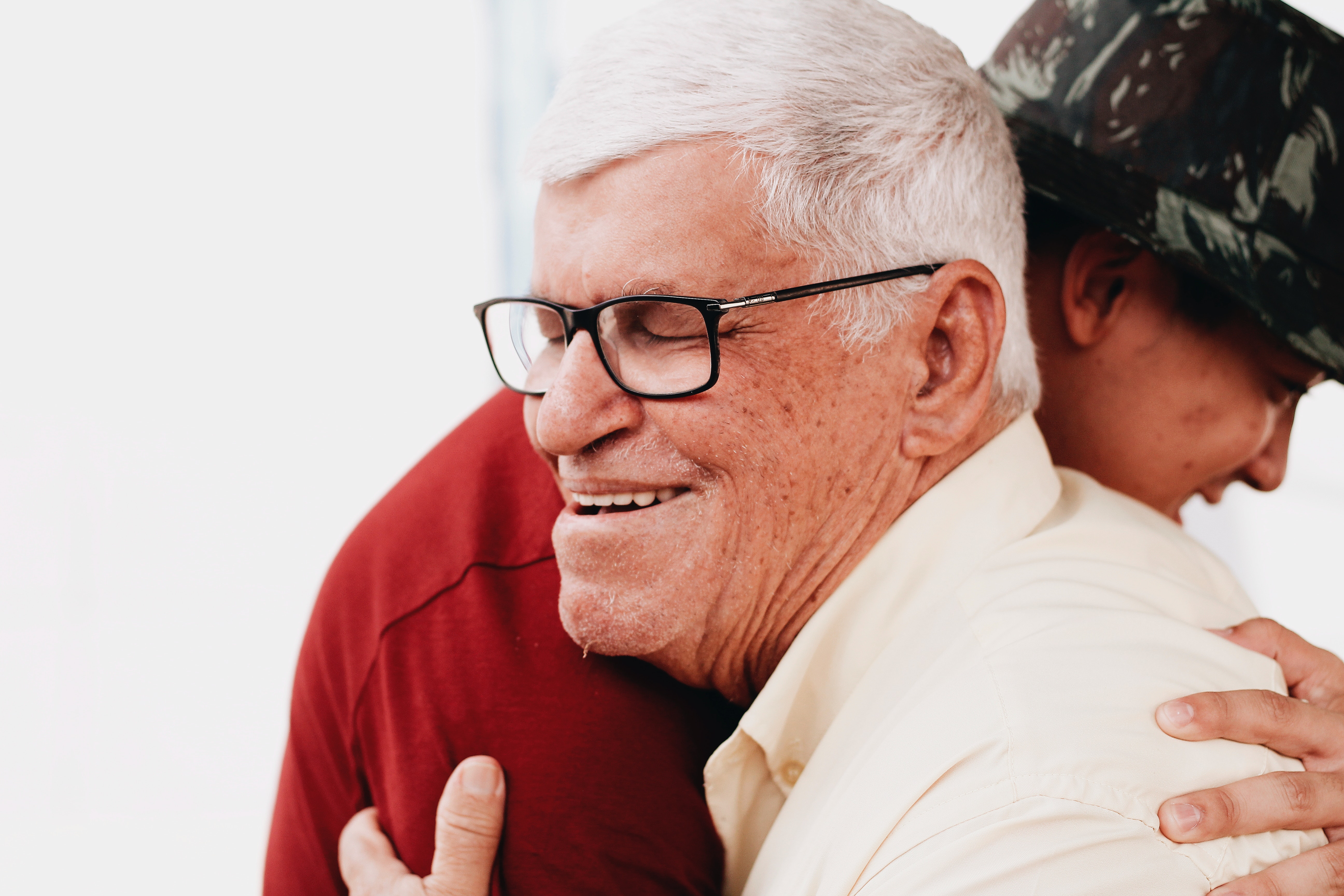 Care worker hugs elderly patient