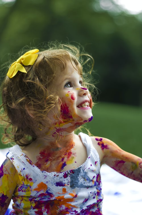 toddler with paint on her body