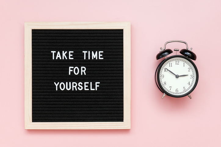 Take time for yourself. Motivational quote on letterboard and black alarm clock on pink background. Top view Flat lay Copy space Concept inspirational quote of the day.