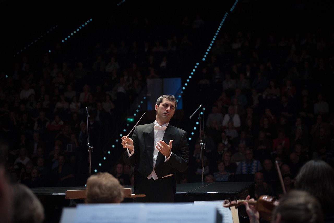 An orchestra conductor in the middle of a performance