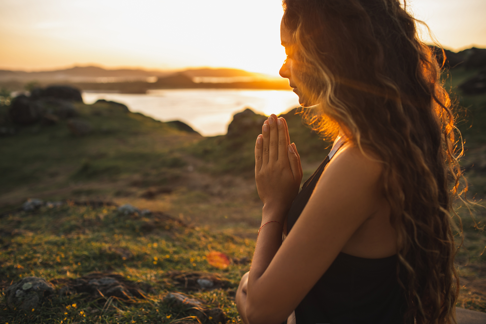 Woman Praying Alone At Sunrise. Nature Background. Spiritual And