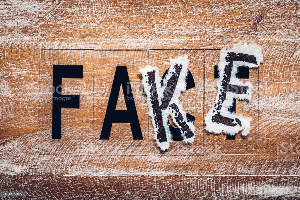 The word fake put on the word fact. The concept of false media information.