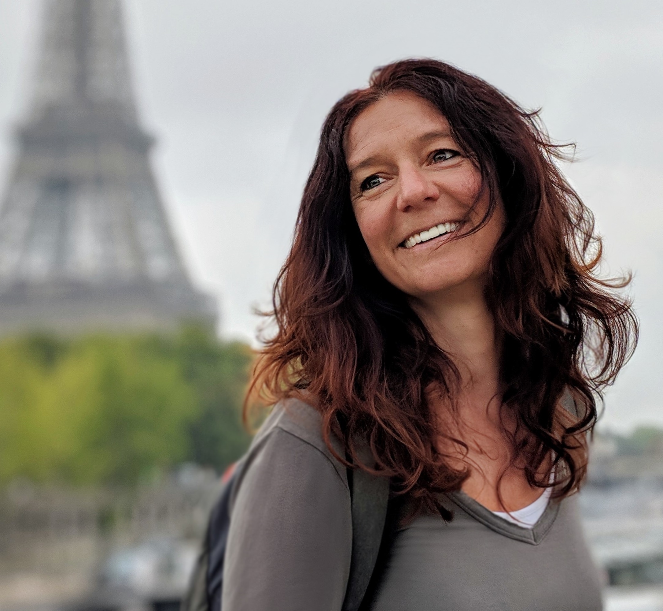 Stella Loichot, Health Coach, in front of the Eiffel Tower in Paris, France, her home country