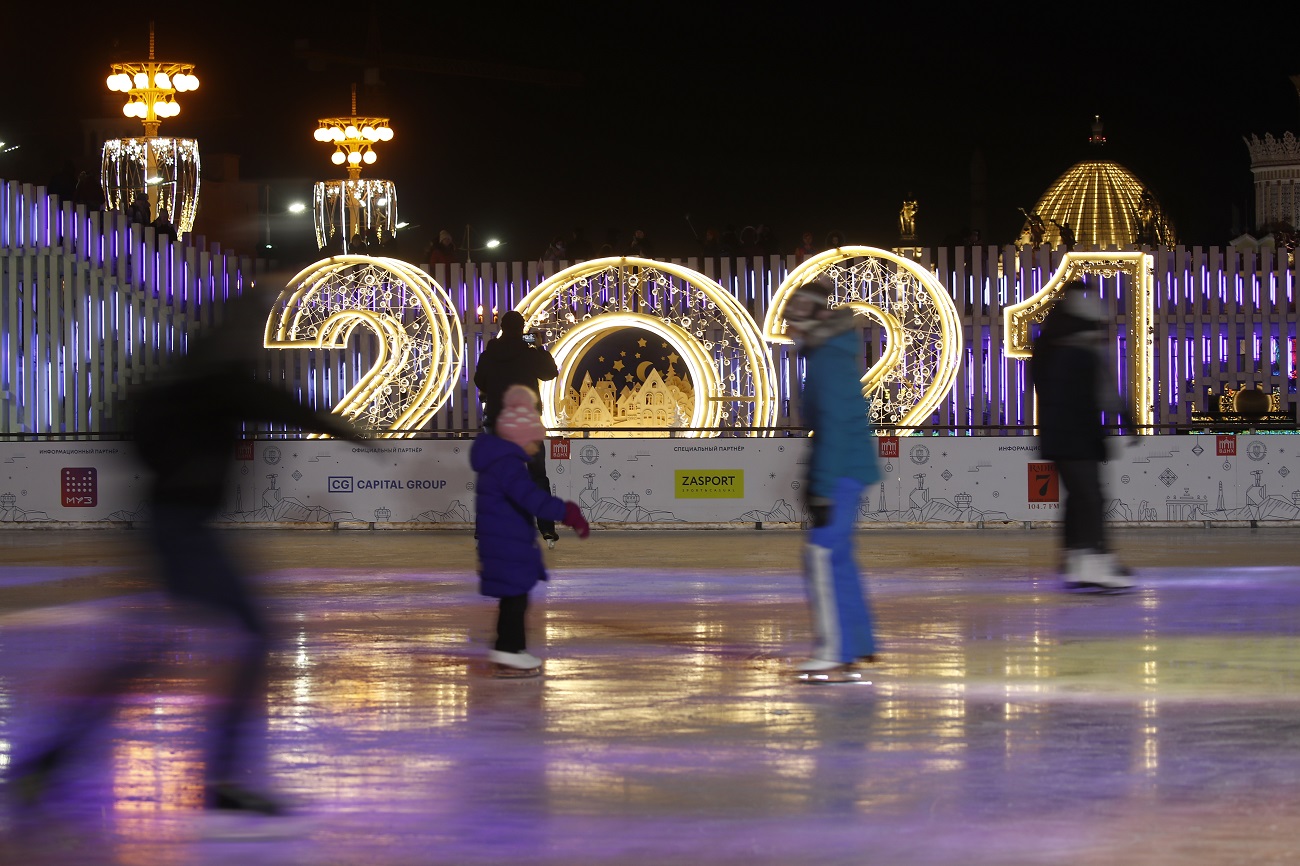 MOSCOW, RUSSIA - DECEMBER 6, 2020: People ice skate at a rink at VDNKh Exhibition Center decorated for winter holidays. Artyom Geodakyan/TASS.No use Russia.