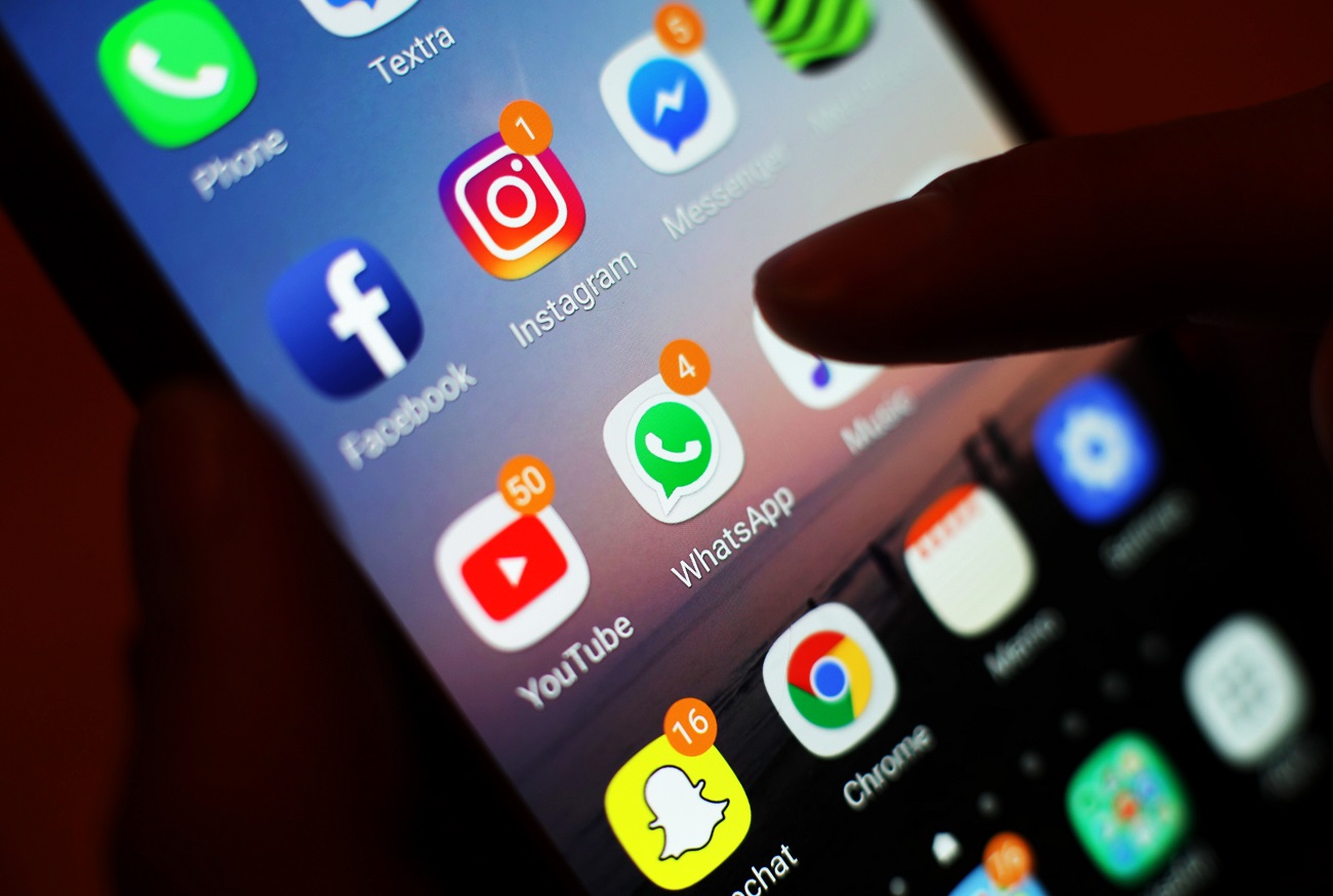The icons of social media apps, including Facebook, Instagram, YouTube and WhatsApp, are displayed on a mobile phone screen, in London.