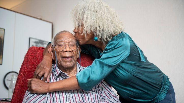 A senior woman gives her 91-year old father a kiss on the head.(LUCY LAMBRIEX ziebinnenzijde.nl / Getty Images)