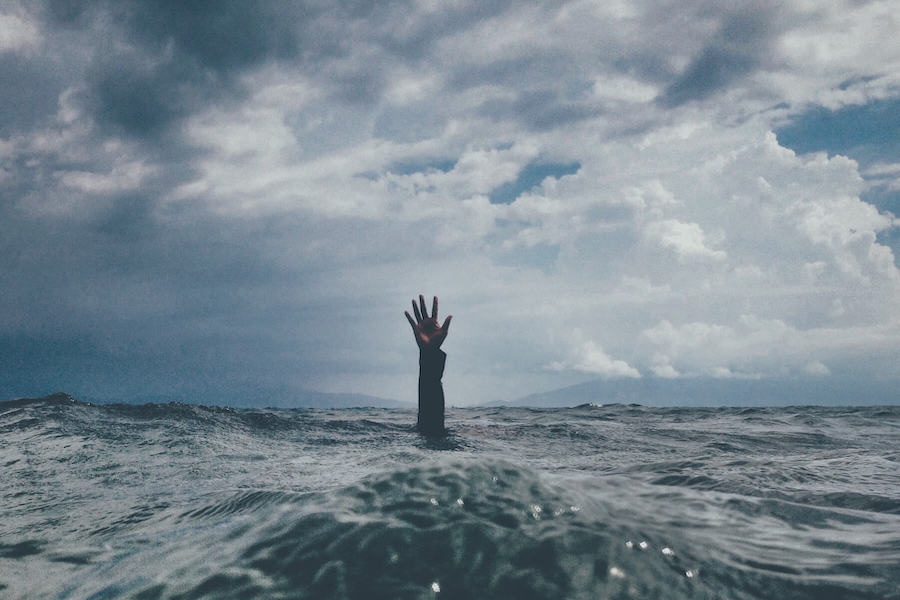 hand coming up through water ocean PTSD in nursing