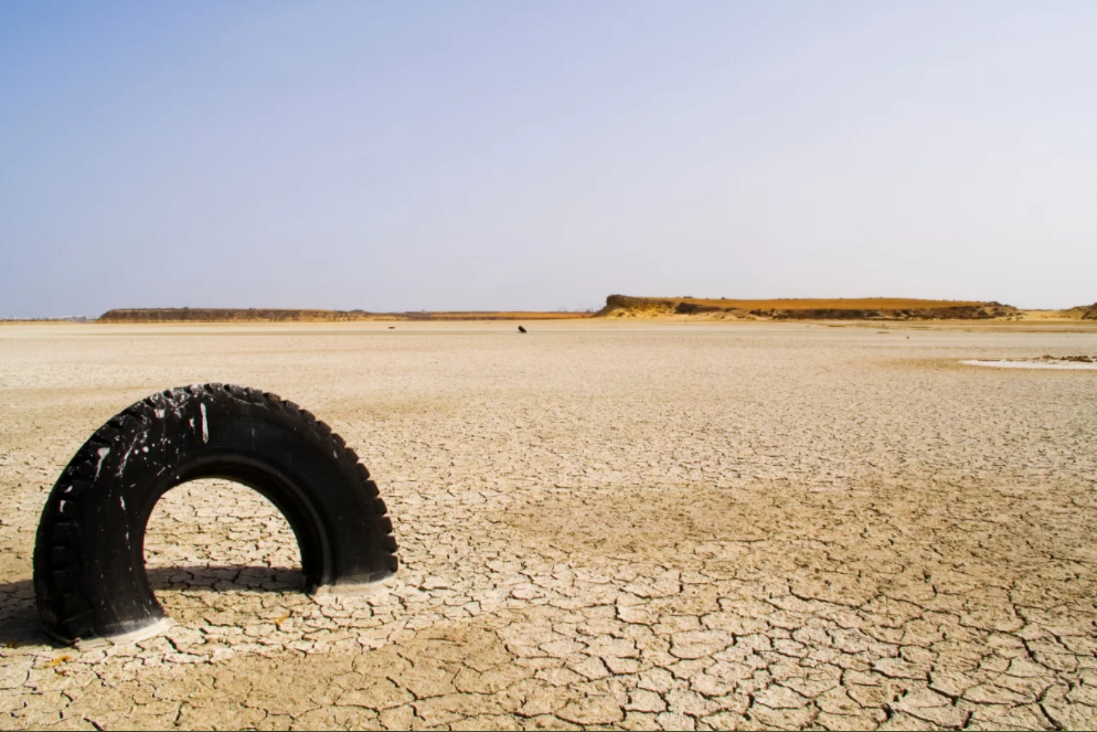 A tire stuck in the desert
