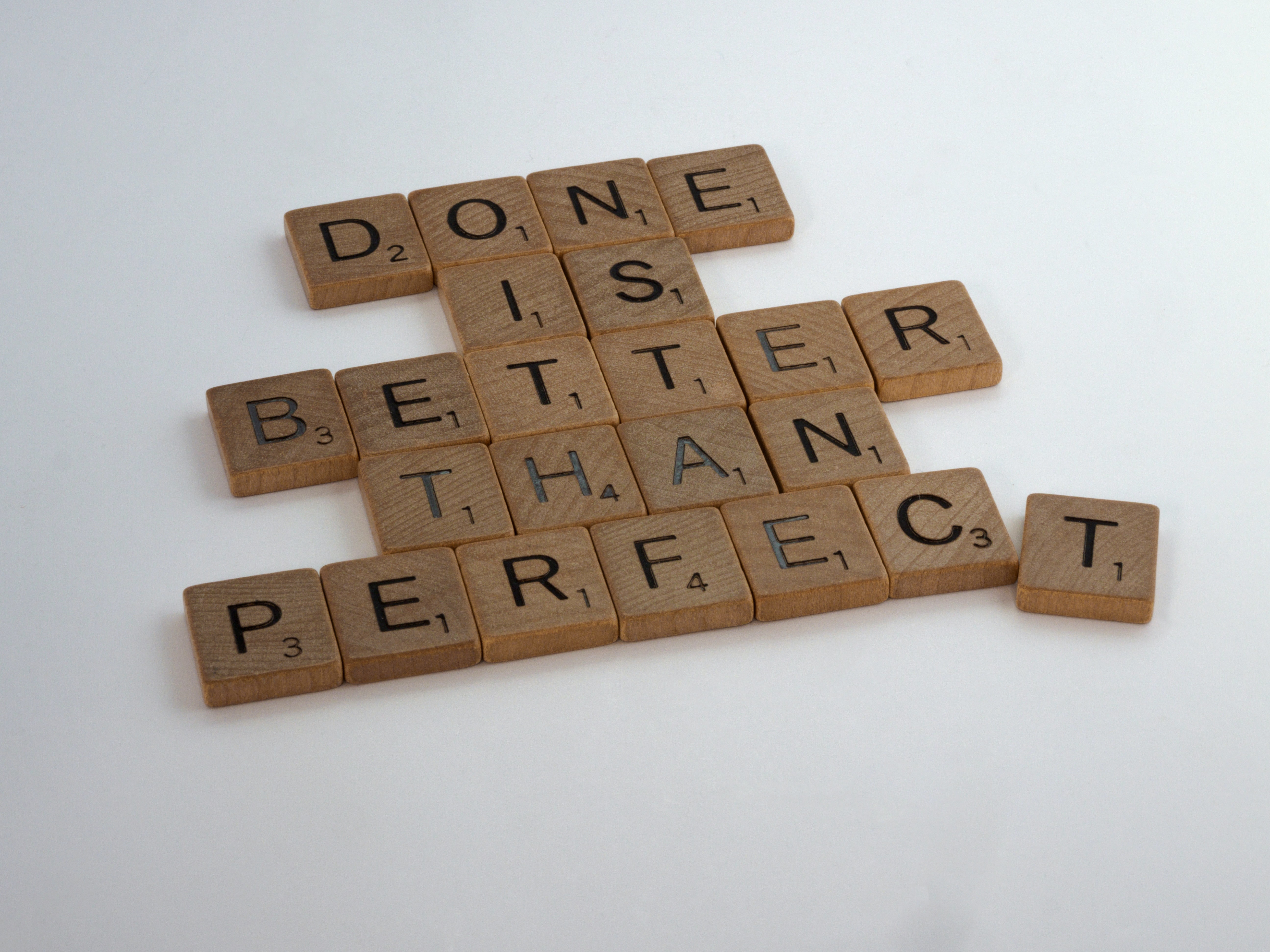 scrabble pieces spelling out &quot;done is better than perfect&quot;