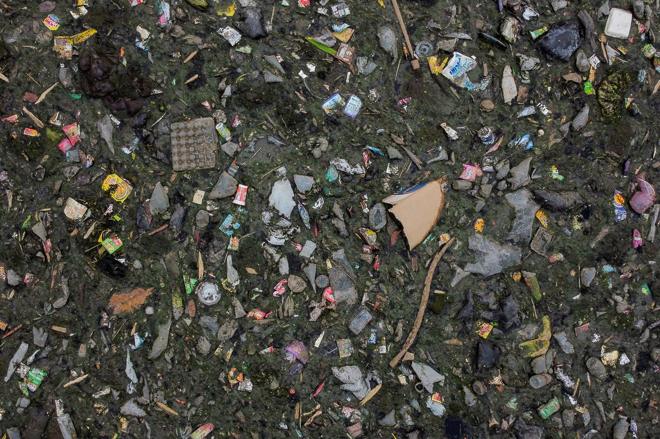 An aerial view shows domestic waste floating on the stream of the Citarum river in Bandung, Indonesia, March 15, 2021. The government has pledged to clean the Citarum river, considered among the world&#039;s most polluted, and make the water there drinkable by 2025, but household and industrial waste have continued to flow in its stream. Picture taken with a drone. REUTERS/Willy Kurniawan    