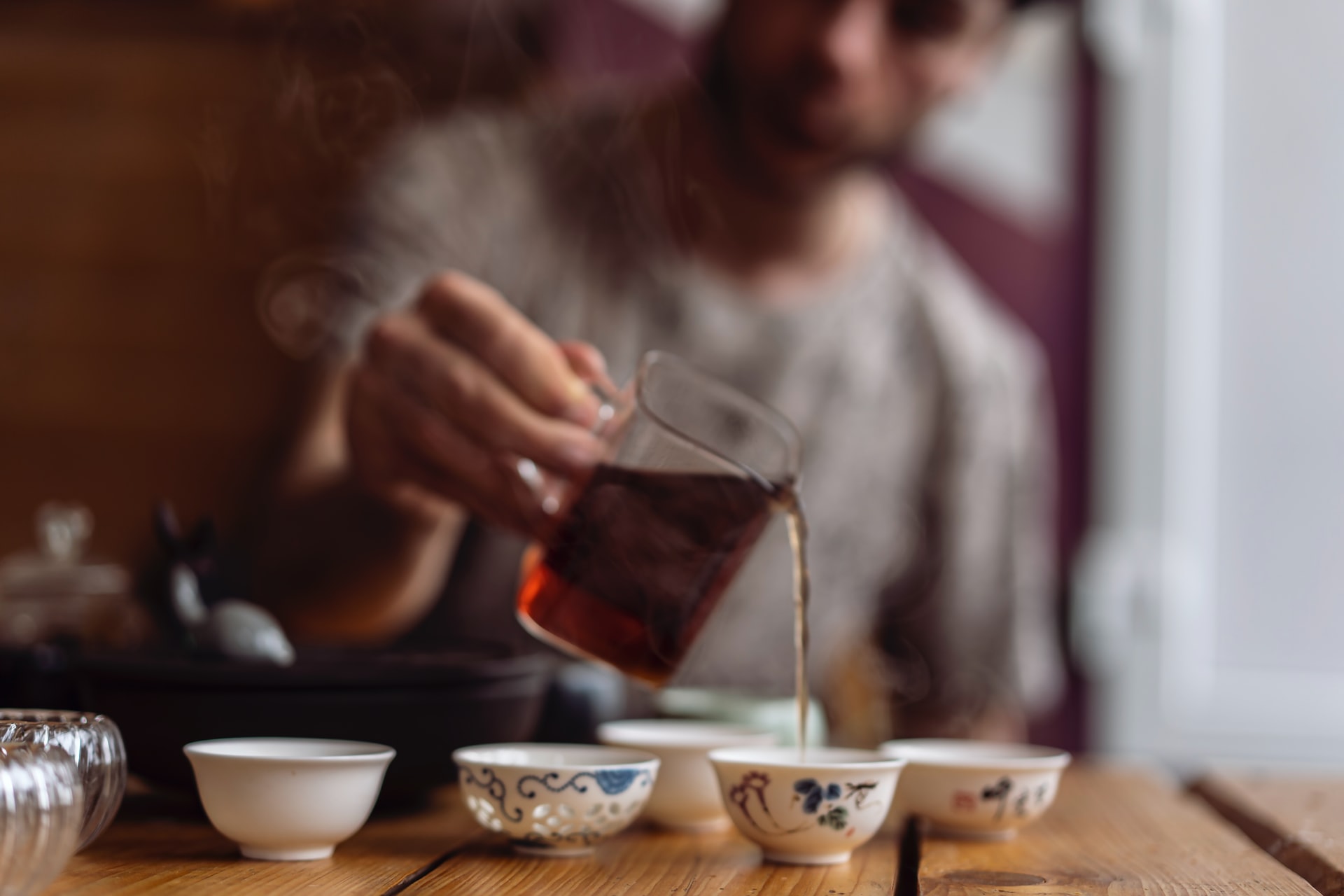 A man pouring tea to tea cups