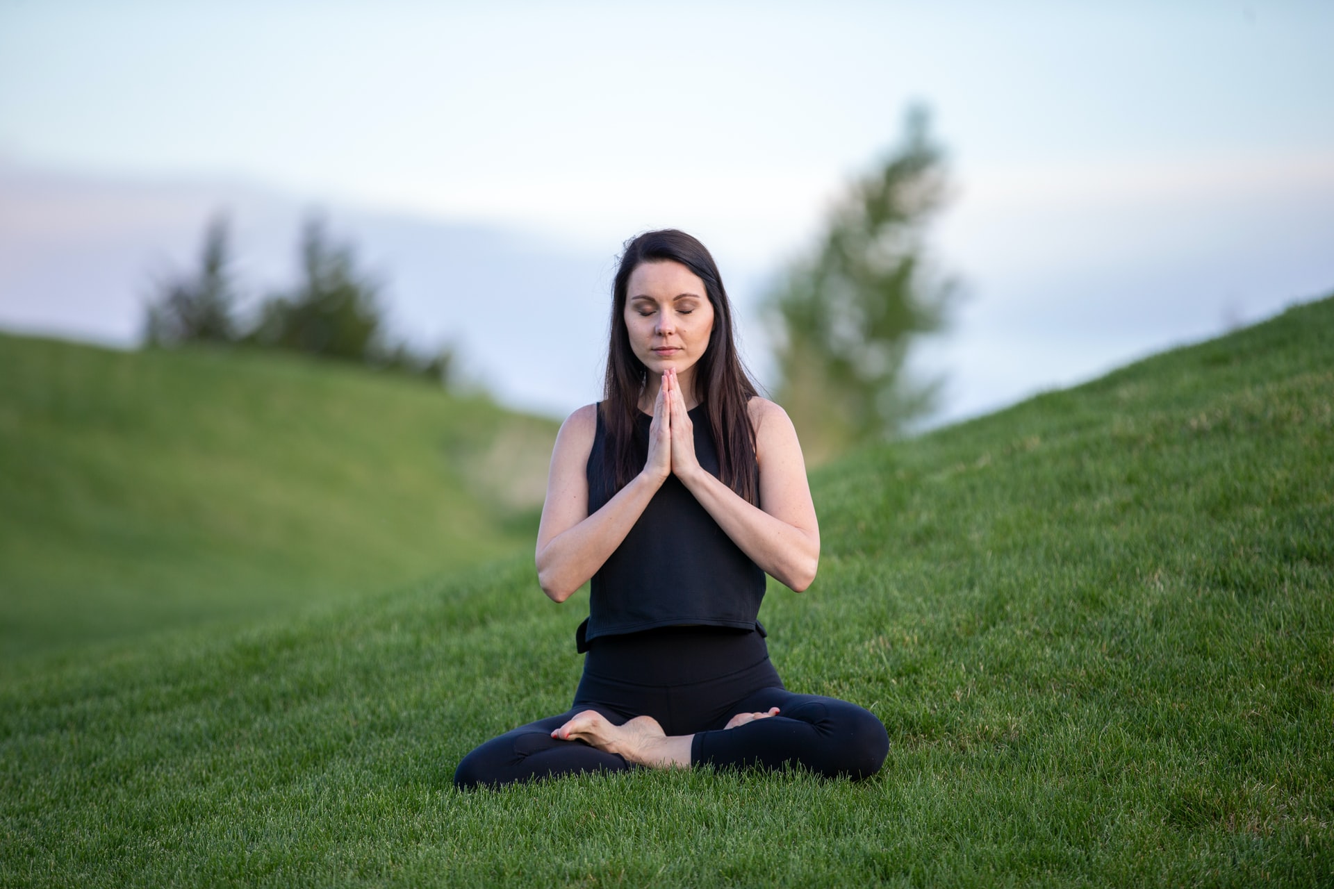 woman-meditating-on-grass