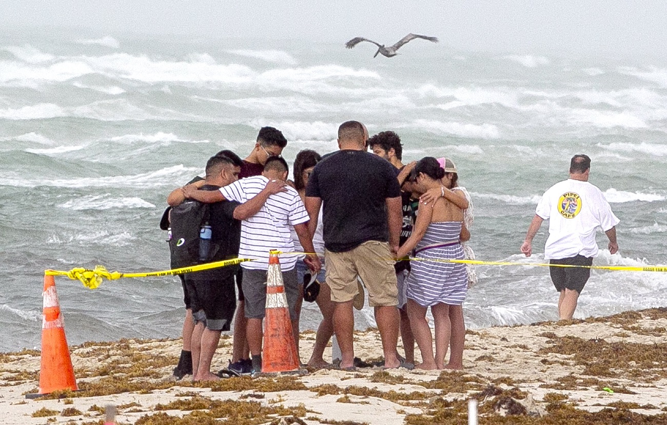NO FILM, NO VIDEO, NO TV, NO DOCUMENTARY - A group of people pray together on the beach next to the site of the Champlain Towers South Condo in Surfside on Friday, June 25, 2021. Photo by Pedro Portal/Miami Herald/TNS/ABACAPRESS.COM