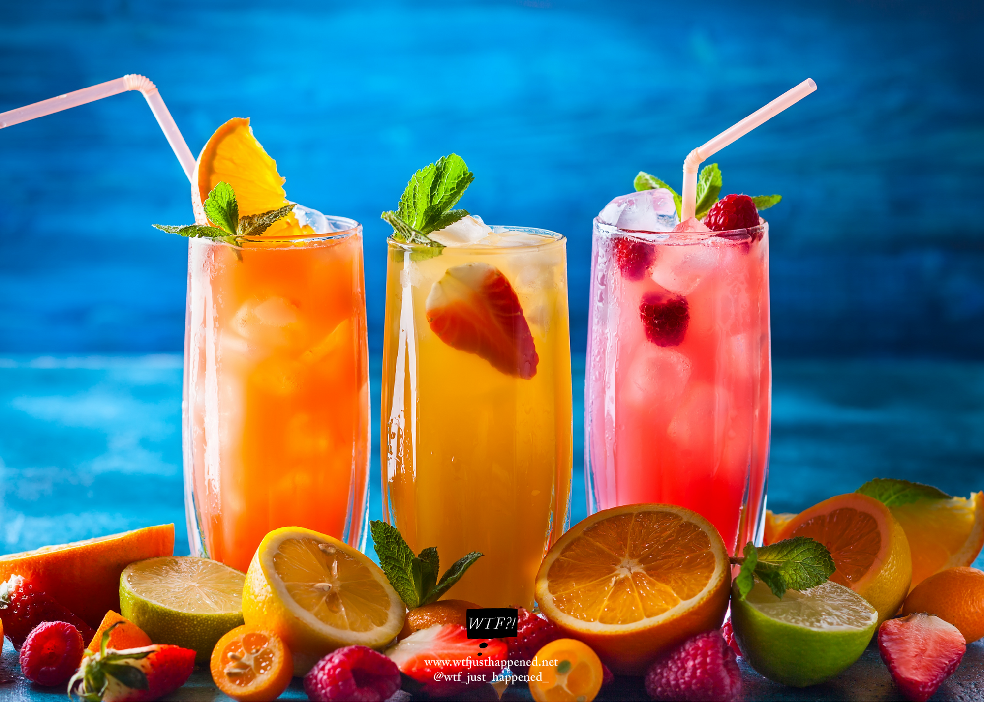 three tropical drinks. orange, strawberry and raspberry