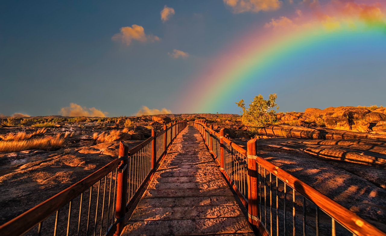 Path leading into the horizon with rainbow