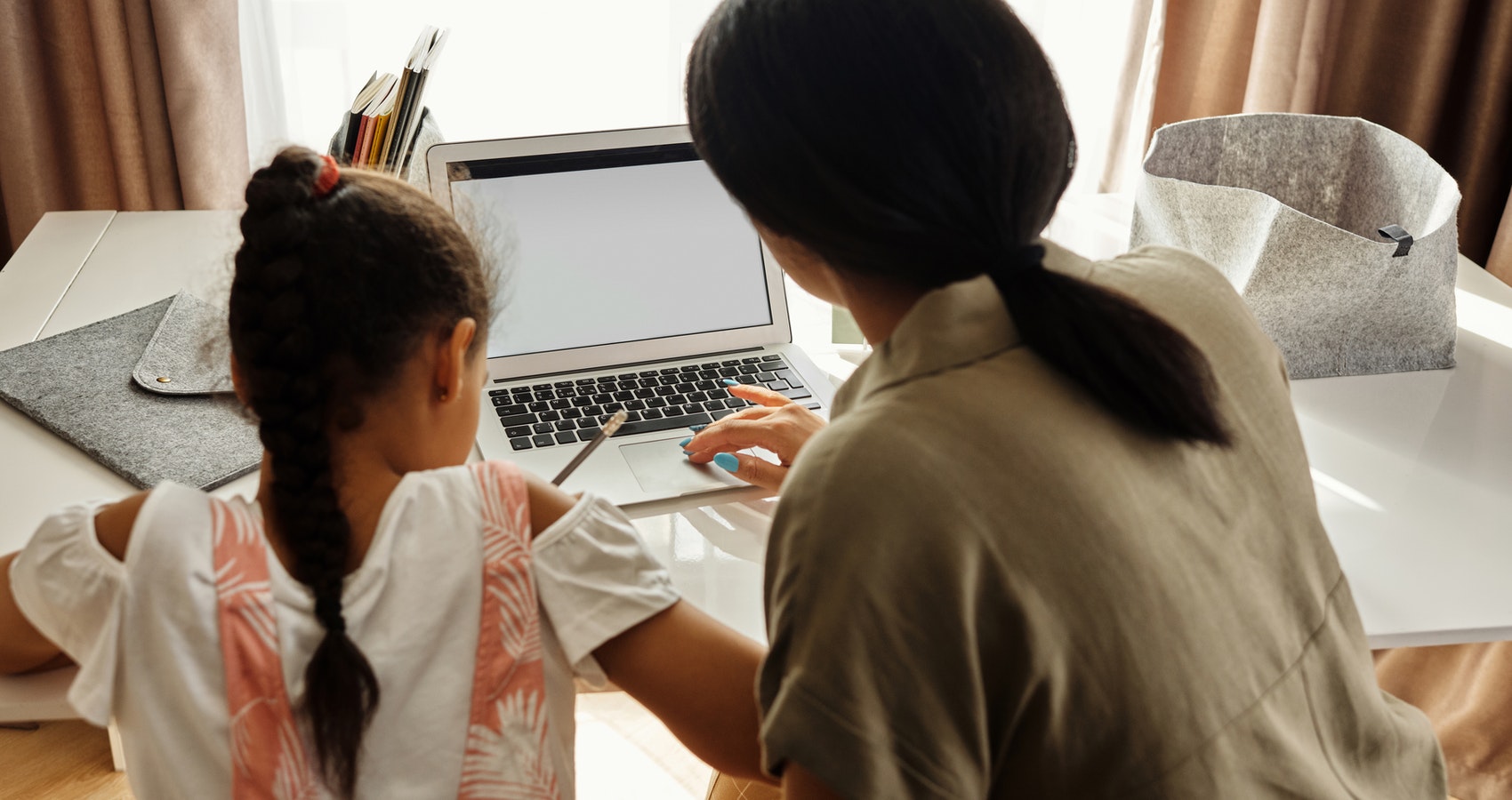 Mom Helping Child With Online Homework