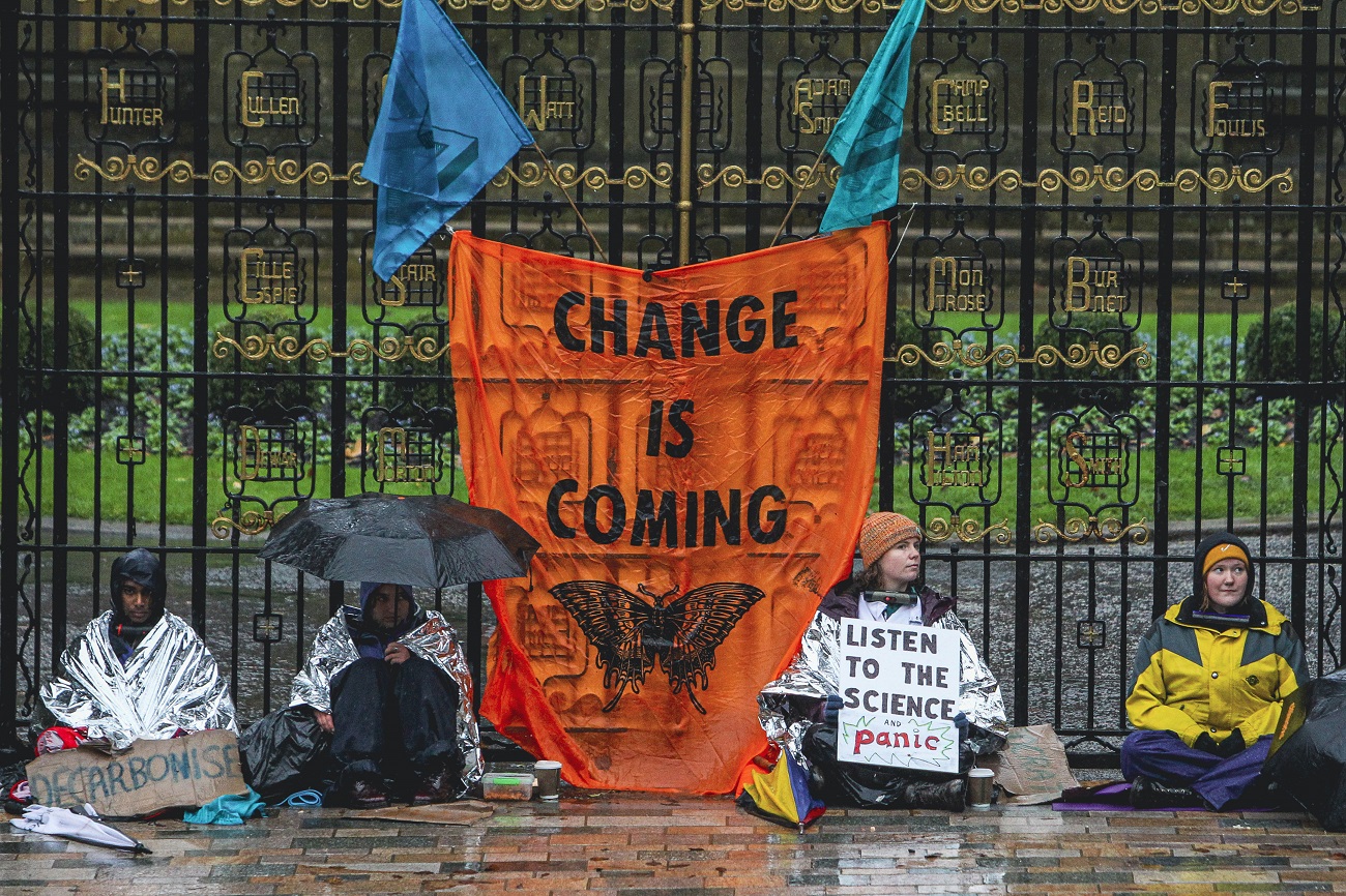 Four activists from Extinction Rebellion Glasgow University lock themselves to the Memorial Gate at the University of Glasgow on October 29, 2021 in Glasgow, Scotland. The activists are calling on the University’s Vice Chancellor Anton Muscatelli to commit the University to implementing the UofG Green New Deal, including all sixty demands which would end the University’s alleged countless ecologically destructive practices. (Photo by Ewan Bootman/NurPhoto)NO USE FRANCE