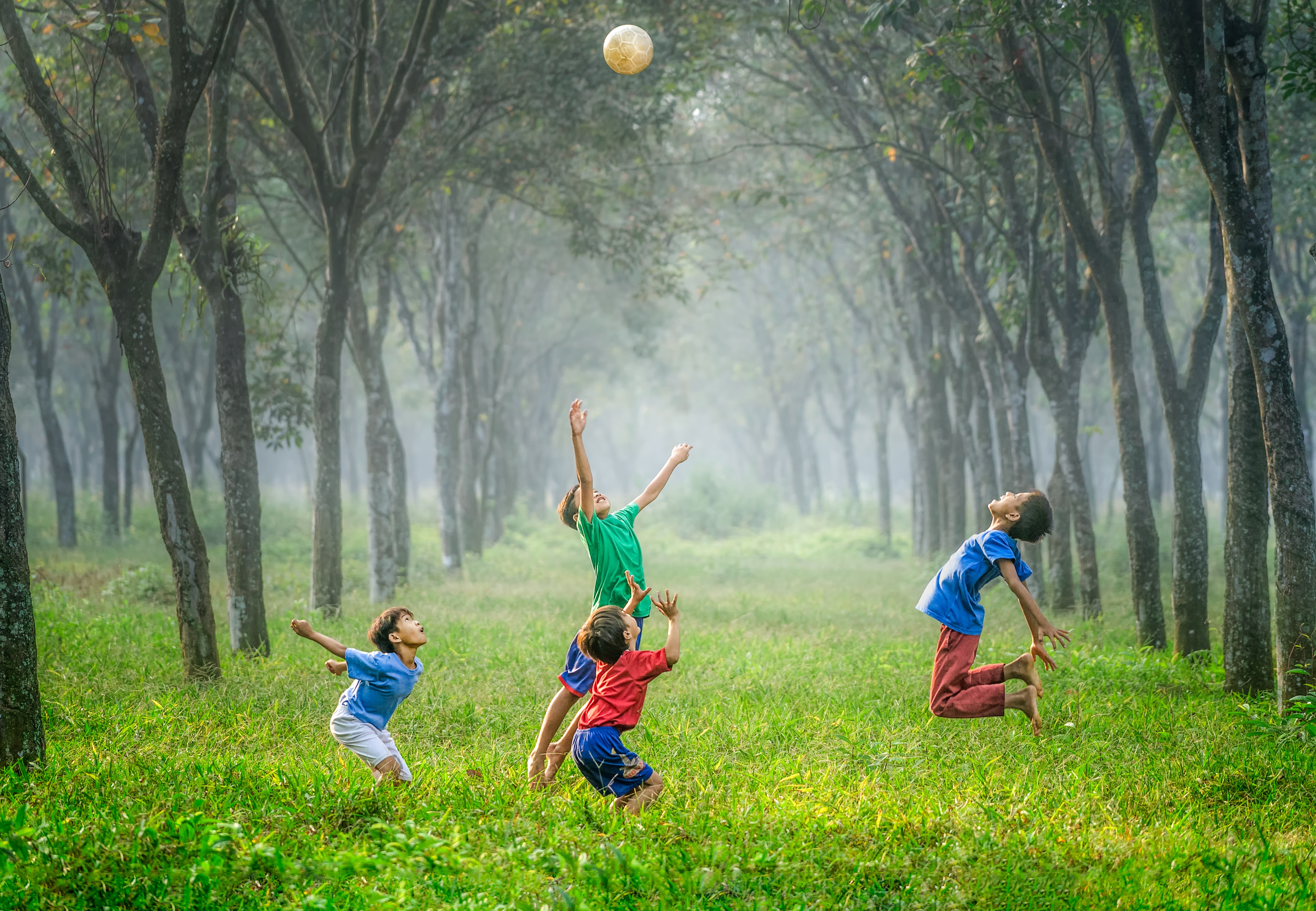 kids jumping for a ball in Indonesia